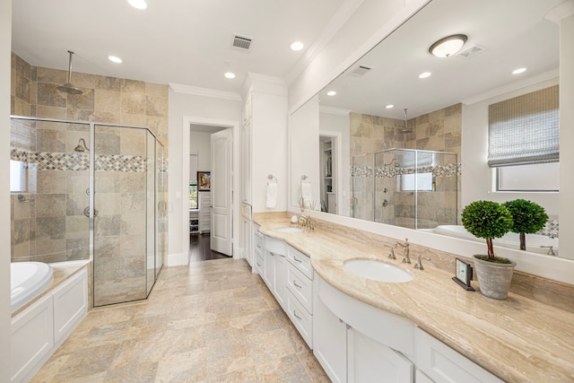 bathroom with ornamental molding, a stall shower, a sink, and double vanity