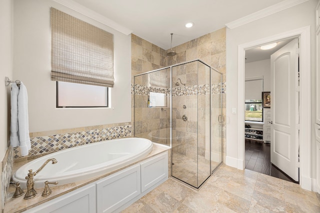 full bath featuring crown molding, a garden tub, and a shower stall