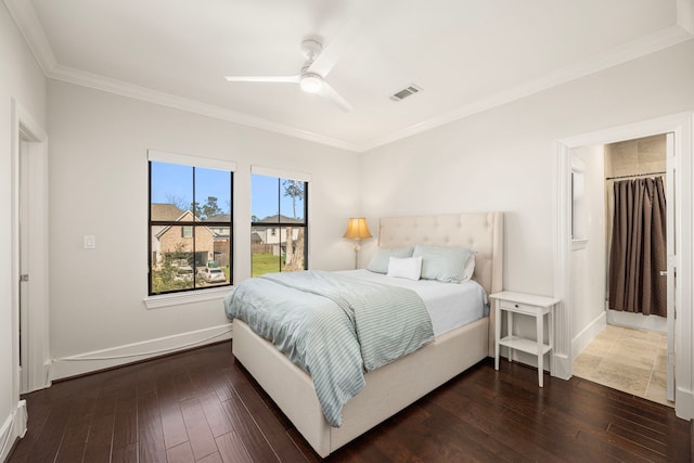 bedroom with crown molding, wood-type flooring, visible vents, and baseboards