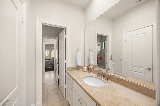 bathroom with vanity and ensuite bath