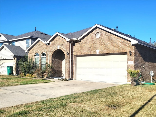 view of front facade with driveway, a garage, a front lawn, and brick siding