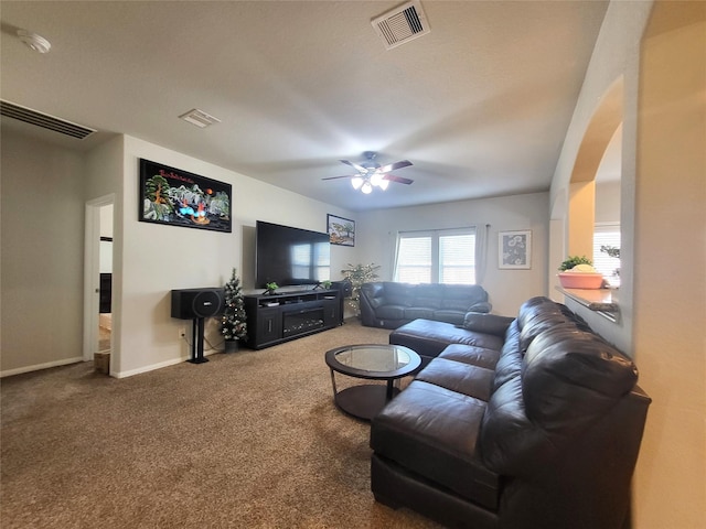 living room featuring carpet, visible vents, and baseboards