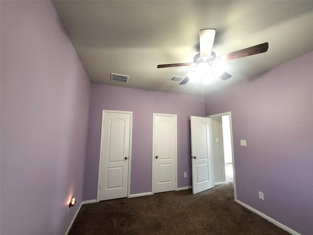 unfurnished bedroom with carpet flooring, visible vents, and baseboards