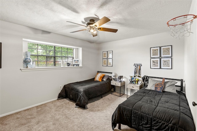 carpeted bedroom with a textured ceiling, a ceiling fan, and baseboards