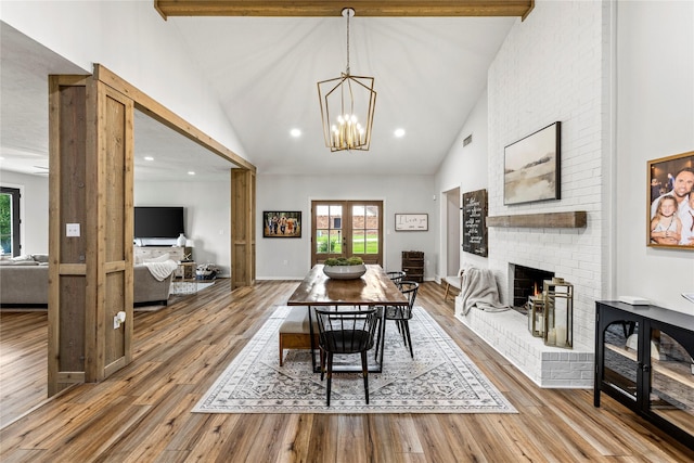 dining room with french doors, wood finished floors, beam ceiling, and a healthy amount of sunlight