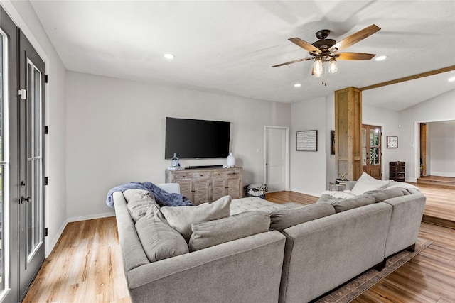 living room featuring recessed lighting, vaulted ceiling, baseboards, and wood finished floors