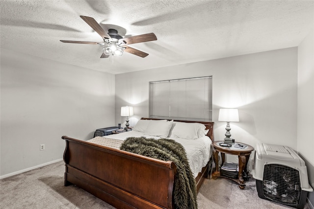 bedroom featuring a textured ceiling, ceiling fan, carpet, and baseboards