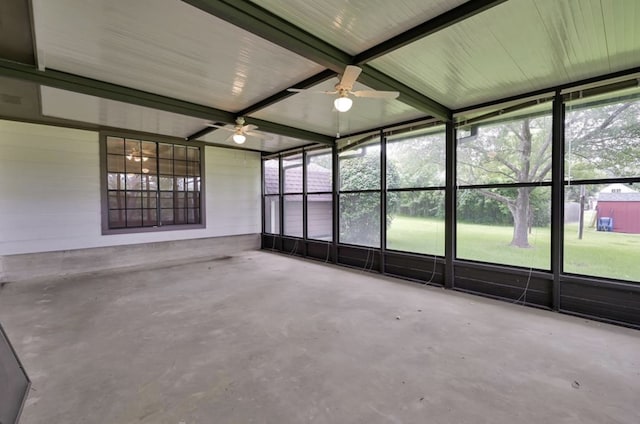 unfurnished sunroom featuring ceiling fan