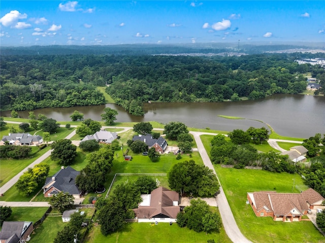 drone / aerial view with a water view, a wooded view, and a residential view