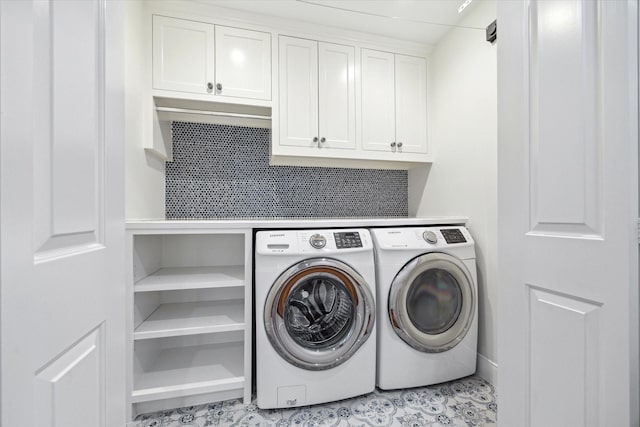 washroom featuring cabinet space and separate washer and dryer