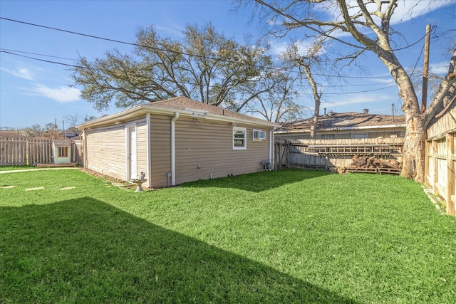 view of yard with a fenced backyard and an outbuilding