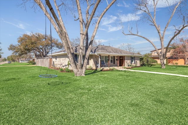 single story home featuring brick siding, a front yard, and fence