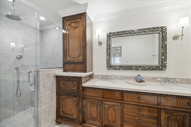 full bath with double vanity, a stall shower, ornamental molding, and a sink