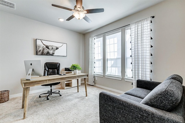 carpeted home office with visible vents, a ceiling fan, and baseboards