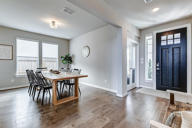 dining area featuring wood finished floors, visible vents, a wealth of natural light, and baseboards