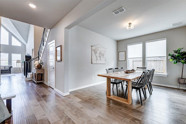 dining room with visible vents, baseboards, and wood finished floors