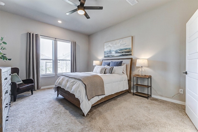 bedroom featuring visible vents, baseboards, and light carpet