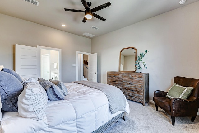 bedroom with visible vents, ensuite bath, recessed lighting, ceiling fan, and light colored carpet