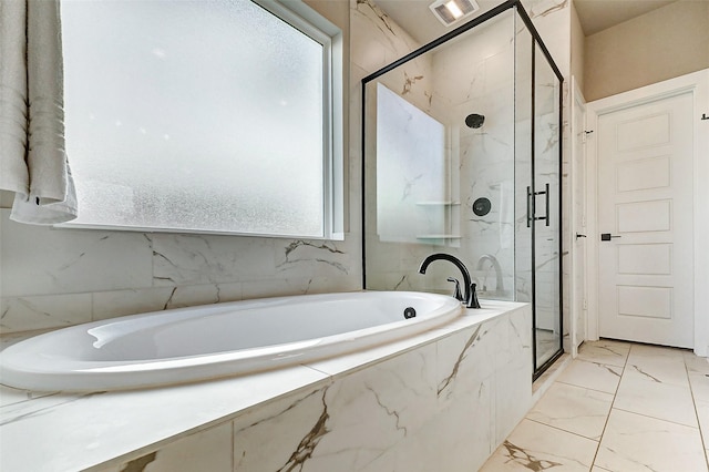 bathroom featuring a garden tub, visible vents, marble finish floor, and a marble finish shower