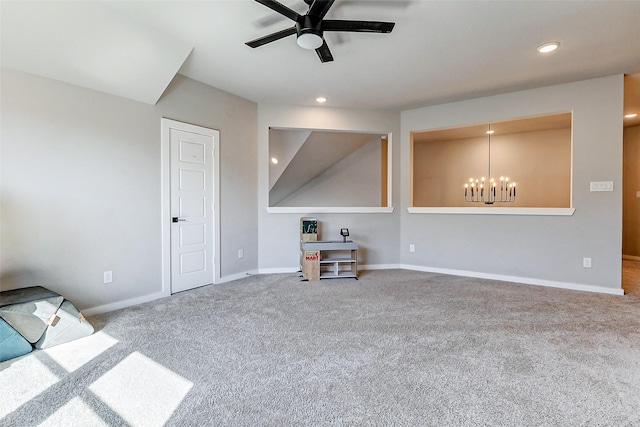 unfurnished living room featuring ceiling fan with notable chandelier, recessed lighting, carpet, and baseboards