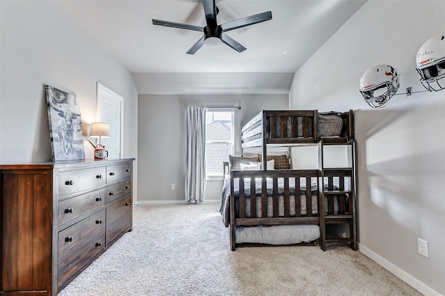 carpeted bedroom featuring baseboards and vaulted ceiling