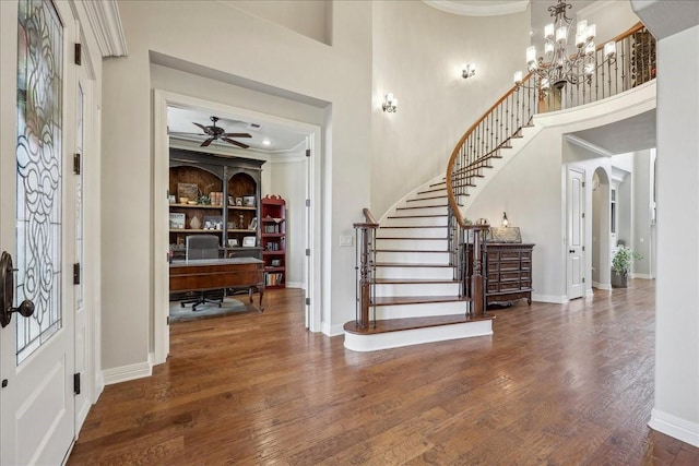 entrance foyer featuring a notable chandelier, baseboards, and wood finished floors