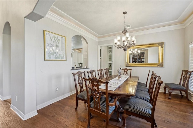 dining space with arched walkways, visible vents, baseboards, and wood finished floors