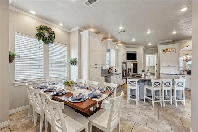 dining room featuring baseboards, recessed lighting, visible vents, and crown molding