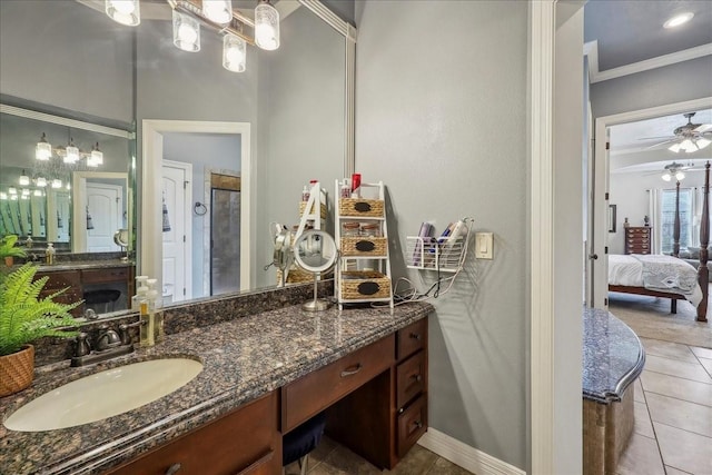 bathroom with a ceiling fan, connected bathroom, ornamental molding, tile patterned flooring, and vanity