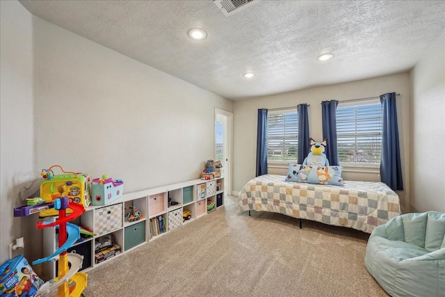 bedroom with a textured ceiling, carpet flooring, visible vents, and recessed lighting