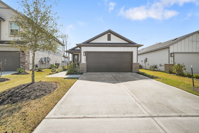 view of front facade featuring driveway, a front lawn, board and batten siding, and brick siding