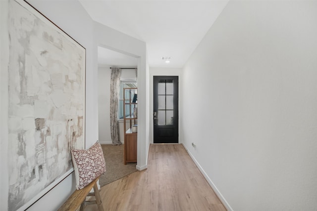 entryway featuring light wood-style flooring, visible vents, and baseboards