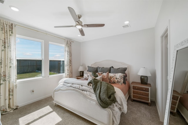 carpeted bedroom featuring a ceiling fan, recessed lighting, visible vents, and baseboards