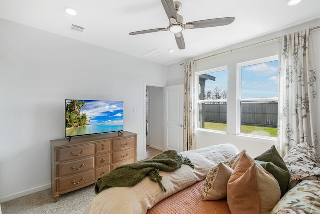 bedroom featuring light carpet, visible vents, baseboards, a ceiling fan, and recessed lighting