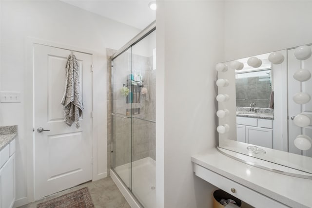 bathroom with a shower stall and vanity