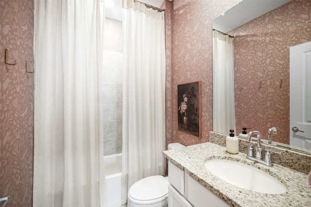 bathroom featuring toilet, wallpapered walls, shower / bath combo, and vanity