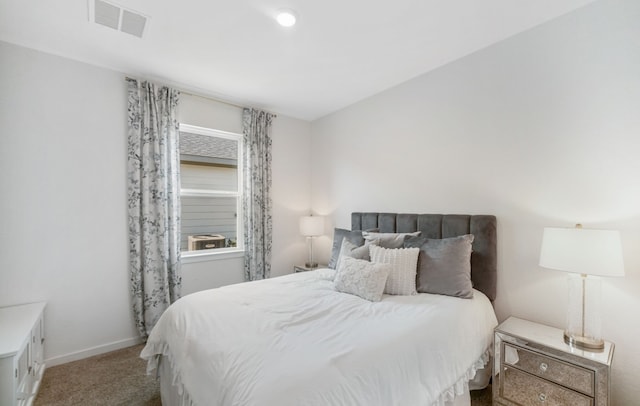 carpeted bedroom with visible vents and baseboards