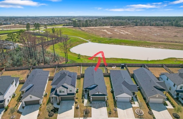 birds eye view of property featuring a water view and a residential view