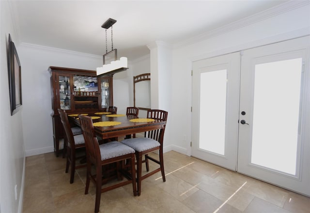 dining area with ornamental molding, french doors, and baseboards