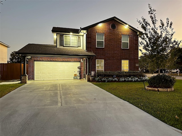 traditional-style home with an attached garage, brick siding, fence, driveway, and a front lawn