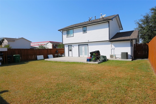 rear view of property with a fenced backyard, central AC, french doors, a lawn, and a patio area