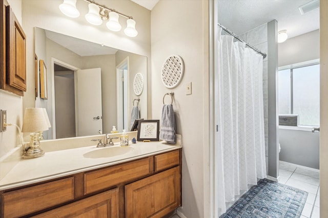 full bathroom with curtained shower, visible vents, baseboards, vanity, and tile patterned floors