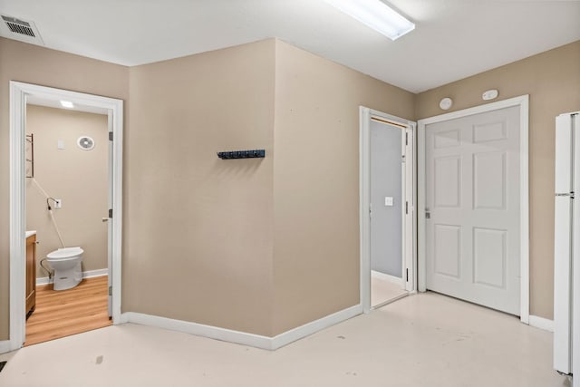 interior space featuring visible vents, finished concrete flooring, and baseboards