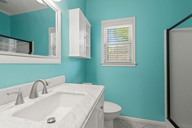 bathroom with baseboards, vanity, toilet, and tile patterned floors