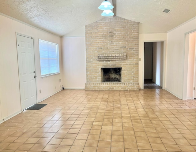 unfurnished living room featuring lofted ceiling, light tile patterned floors, a textured ceiling, visible vents, and a brick fireplace