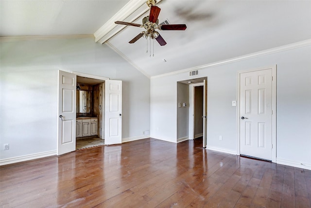 spare room featuring crown molding, visible vents, vaulted ceiling with beams, and wood finished floors