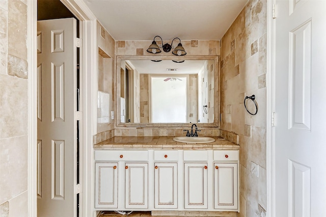 bathroom with tile walls and vanity