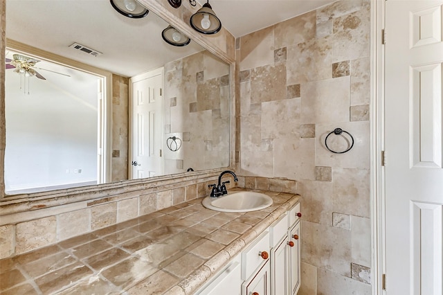 bathroom with vanity, visible vents, and a ceiling fan