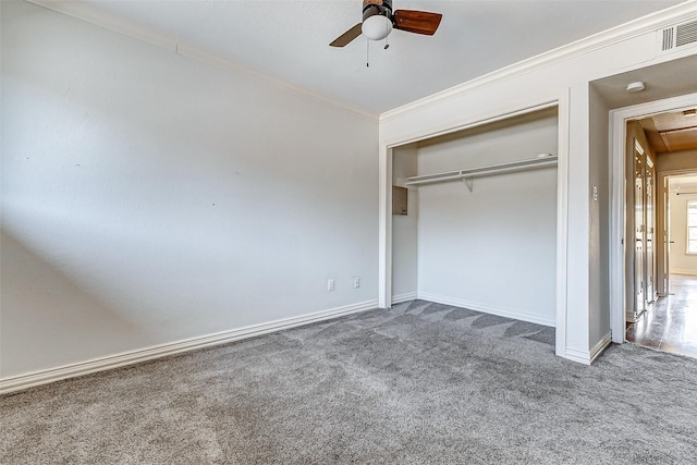 unfurnished bedroom with attic access, visible vents, carpet flooring, and ornamental molding