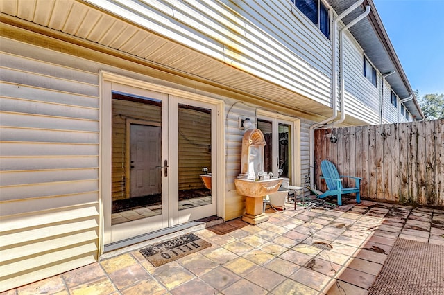 view of patio with french doors and fence